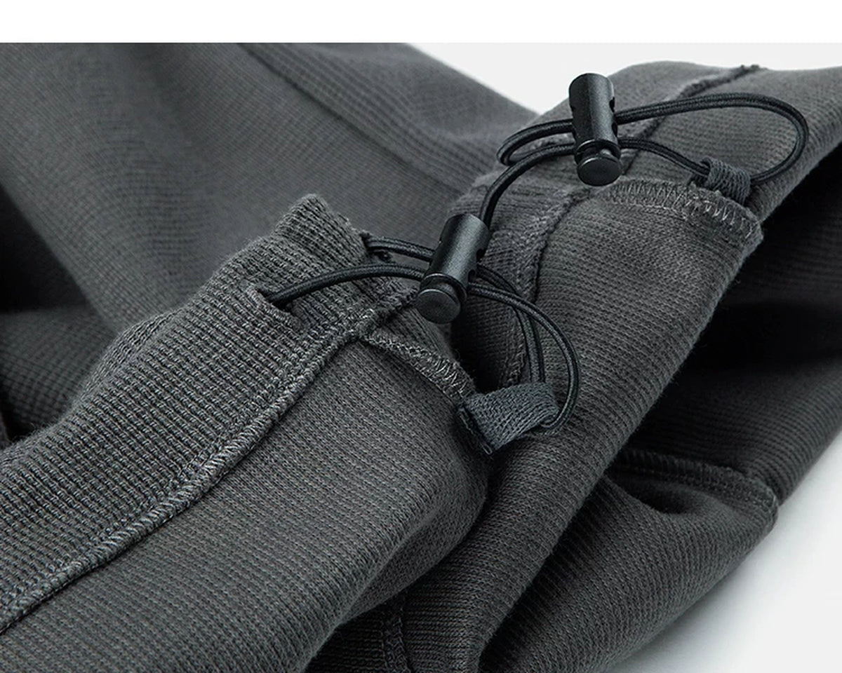 IDLT waffle sweatpants, dark gray ankle drawcords.