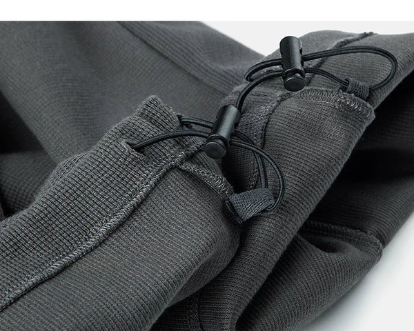 IDLT waffle sweatpants, dark gray ankle drawcords.