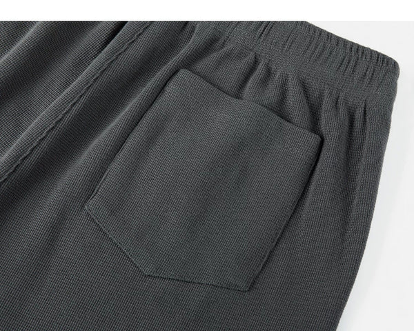 IDLT waffle sweatpants, dark gray back pocket close-up.