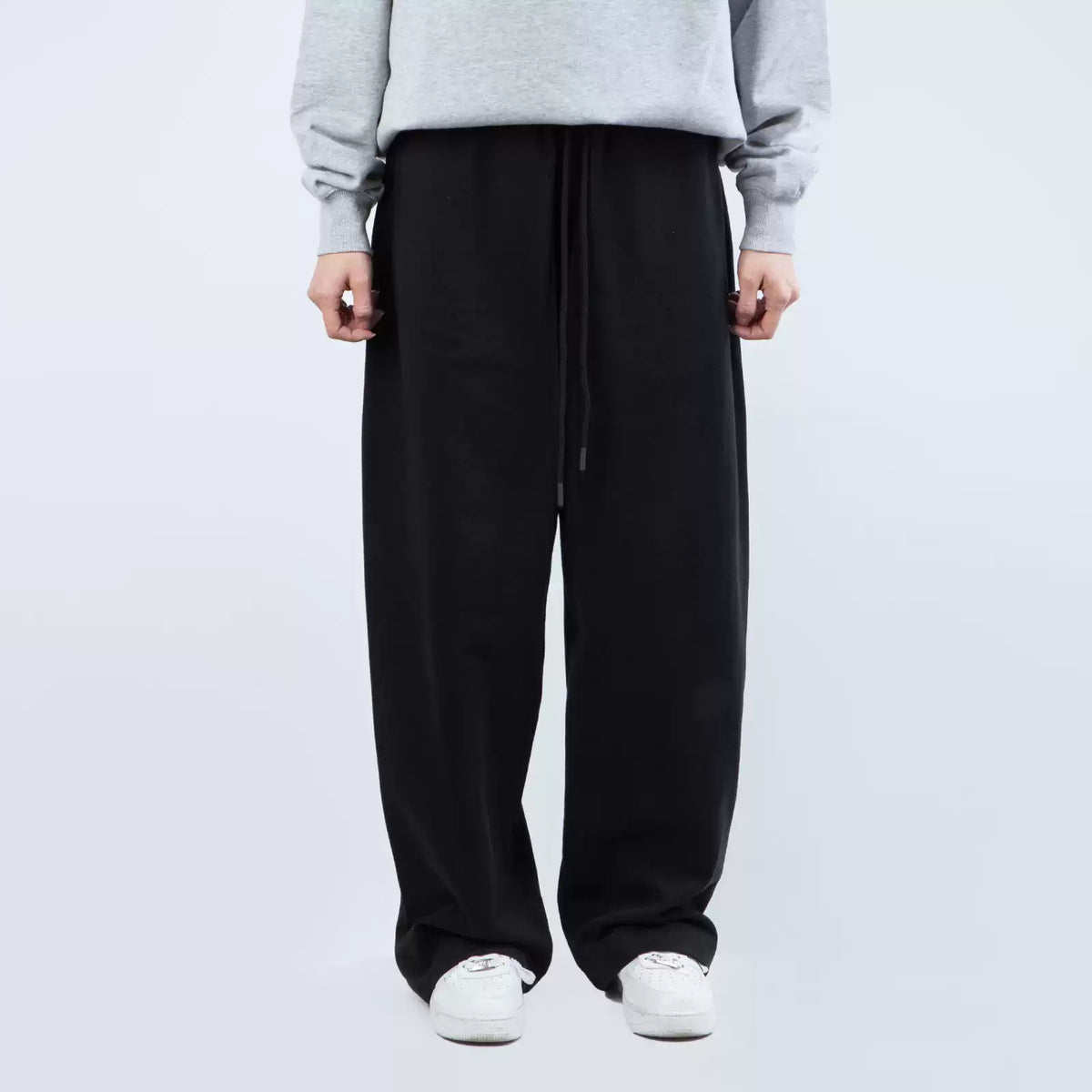 IDLT wide leg sweatpants, black front on model.
