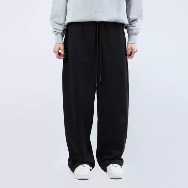 IDLT wide leg sweatpants, black front on model.