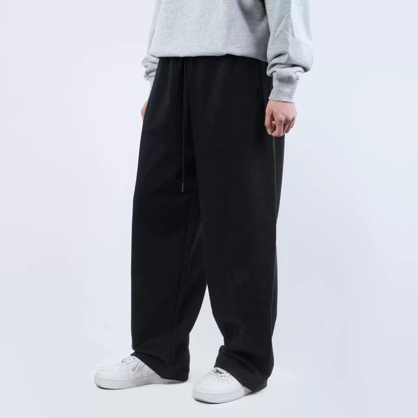 IDLT wide leg sweatpants, black three-quarter view on model.