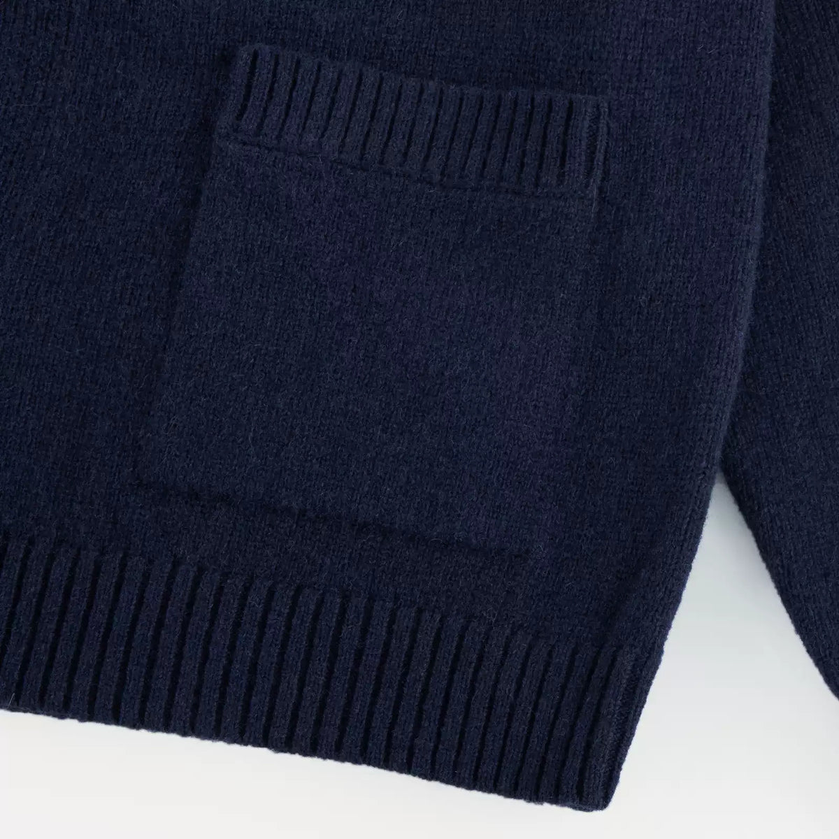 IDLT stand collar cardigan, navy patch pocket close-up.