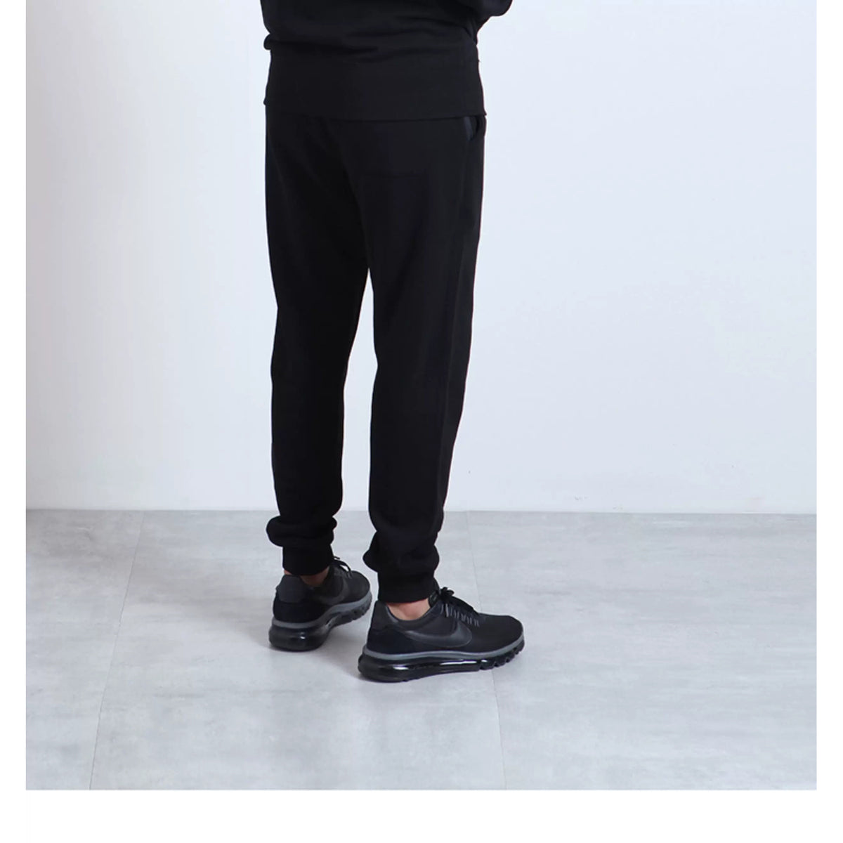 IDLT joggers, black side on model.