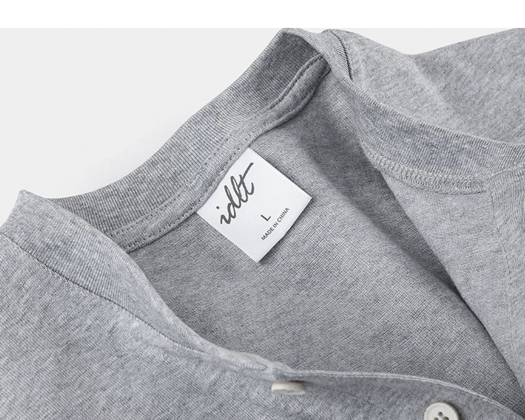 IDLT short sleeve henley, heather gray neckline and label.
