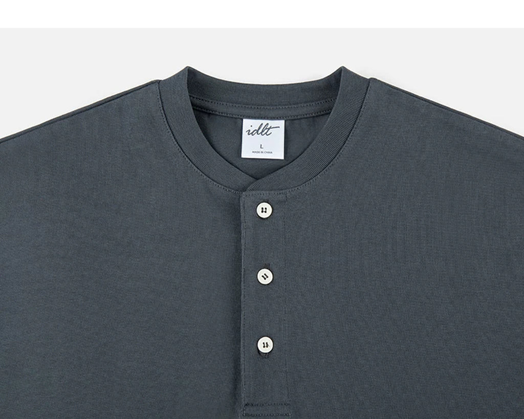 IDLT short sleeve henley, dark gray neckline and buttons.