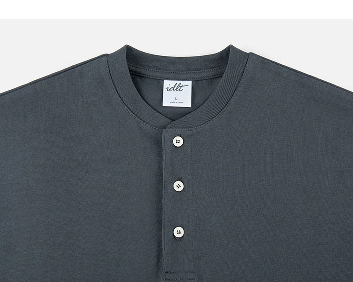 IDLT short sleeve henley, dark gray neckline and buttons.