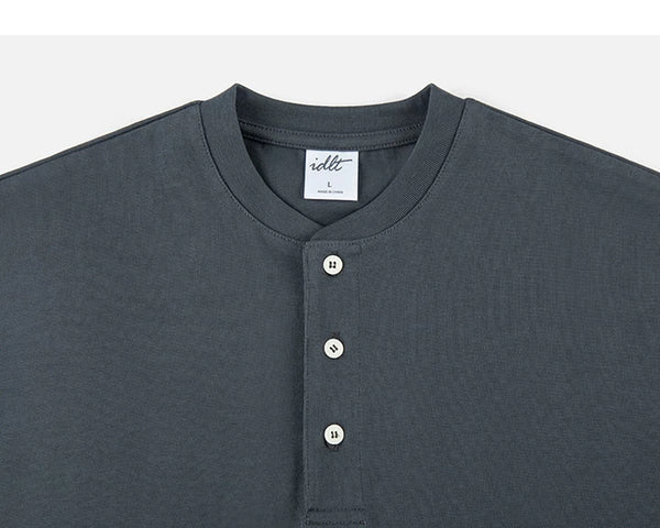 IDLT short sleeve henley, dark gray neckline and buttons.