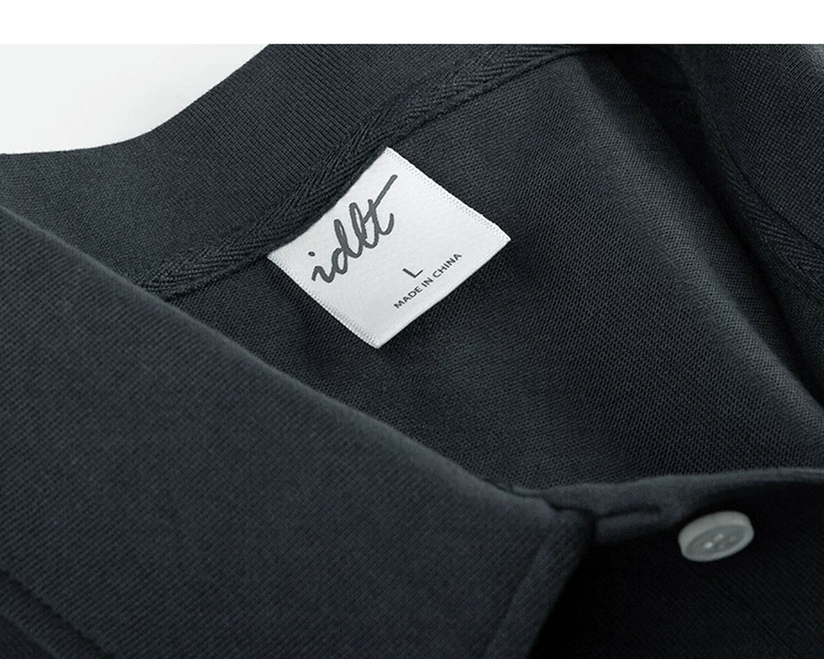 IDLT short sleeve polo, dark gray neckline and label.